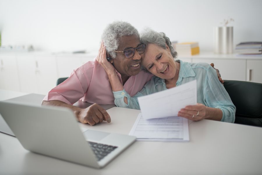 A mature couple reading a document together at home; illustrative stock photograph.